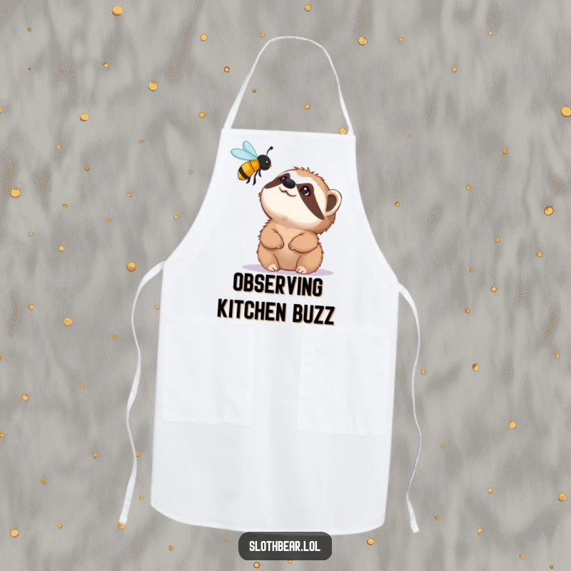 Funny apron featuring a small sloth bear character looking up with fascination at a buzzing bee, adding kitchen humor to cooking.